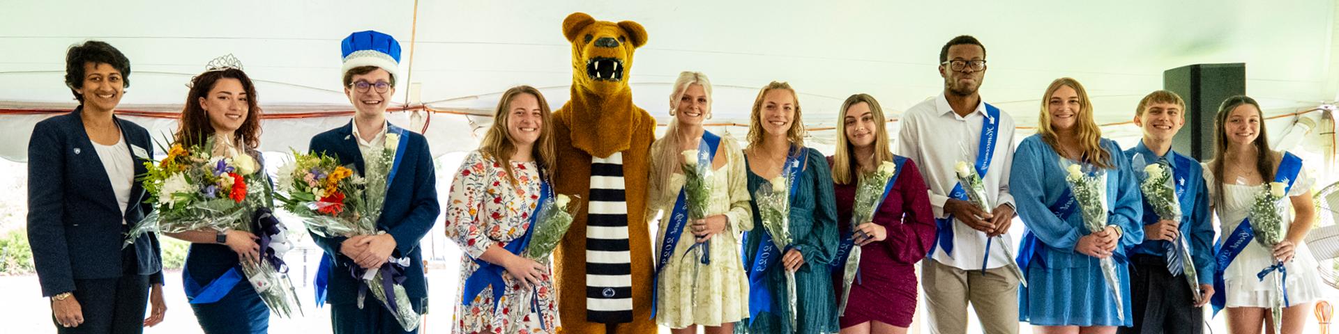 2023 Homecoming Court members pose for a picture under a tent